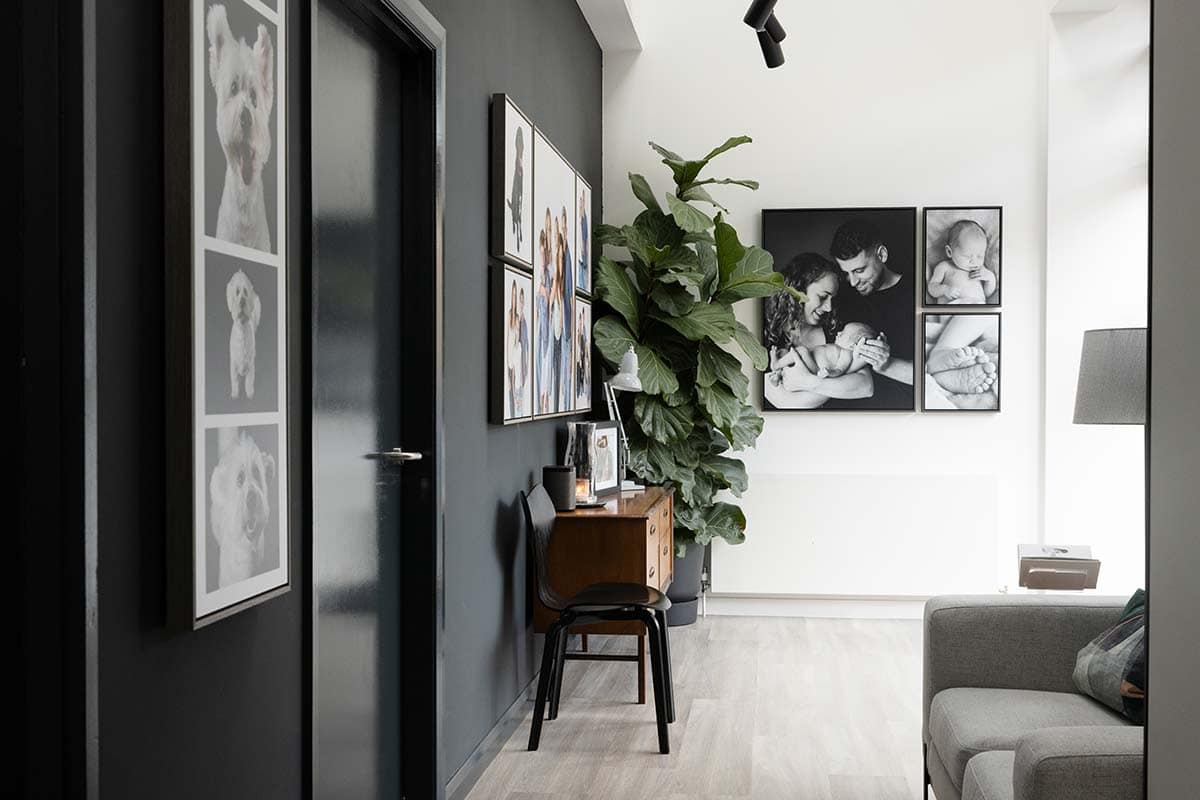 An image showing Edinburgh photographers Blue SKy Photography's studio gallery. There are lots of images on the wall and a table with products displayed on it.
